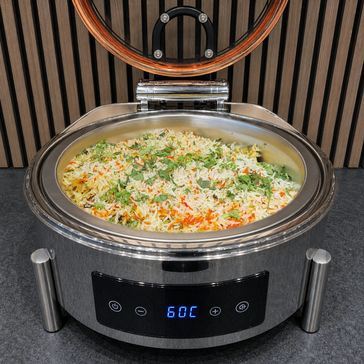 Vegetable dum biryani served in a round buffet chafing dish