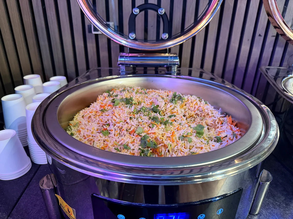 Vegetable biryani served in a round buffet chafing dish