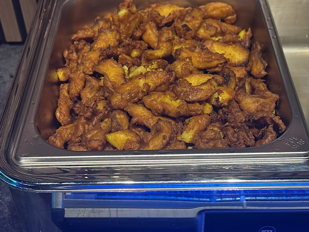 Vegetable pakora served in a buffet chafing dish