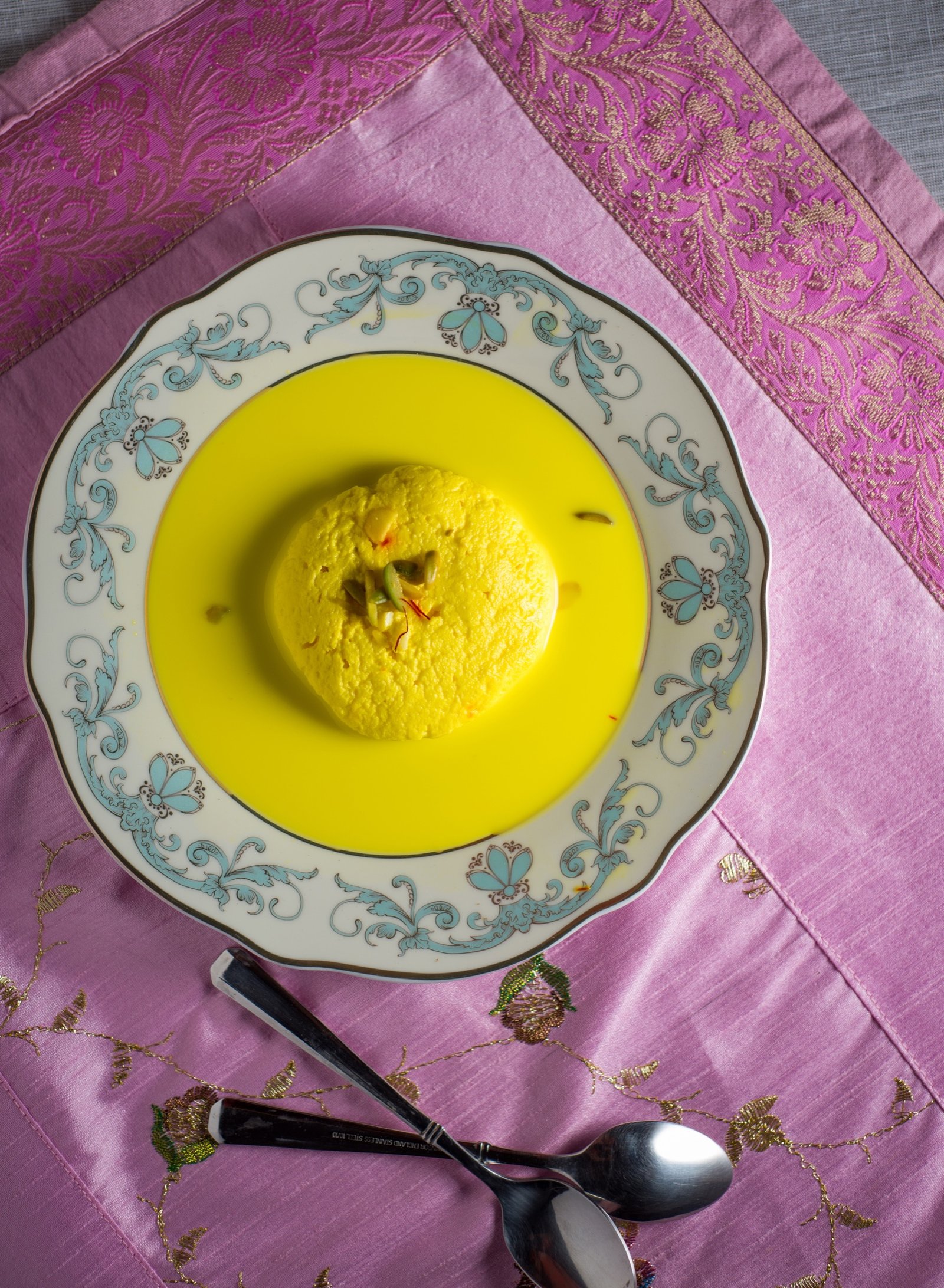 Saffron rasmalai served on a decorative plate